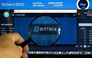 Bittrex logo on a computer screen with a magnifying glass