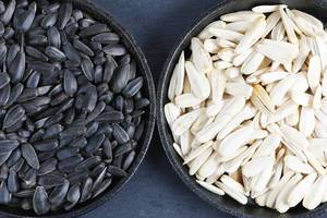 Black and white sunflower seeds in to small pans (Flip 2019)