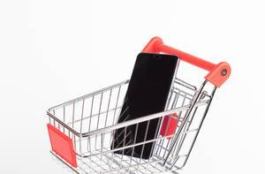 Black smartphone in shopping cart