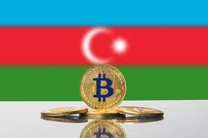 Blau-goldene Bitcoins vor der Nationalflagge Aserbaidschans