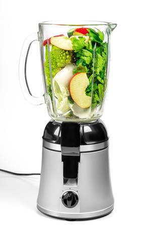 Blender with cabbage, apple slices, cucumber and parsley on a white background (Flip 2020)