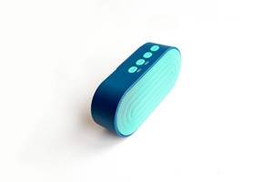 Blue portable mini speaker on white background