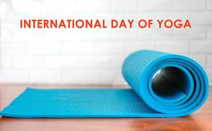 Blue Roll-Up Yoga Mat on a White Background, for fitness and meditation, with the title "international day of yoga"