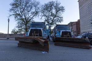 Blue snow plow trucks by Freightliner