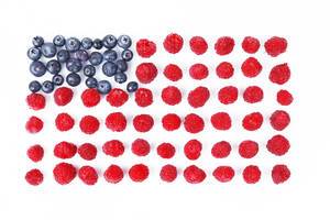 Blueberries and raspberries in USA flag shape, white background