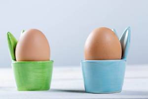 Boiled eggs in green and blue coasters