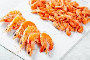 Boiled shrimp of different sizes on white background