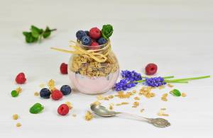 Bokeh Food Photo of Granola Yogurt with Raspberries and Blueberries