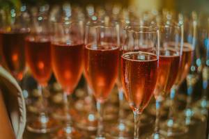Bokeh Photo of Champagne Glasses with Pink Rose Champagne for New Year Celebrations