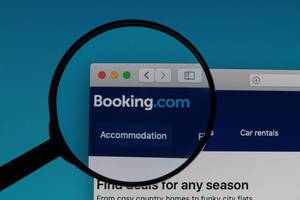 Booking.com logo under magnifying glass
