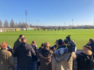Borussia Dortmund fans and a camera operator attend the public training of the Bundesliga team