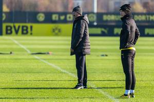 Borussia Dortmund manager Lucien Favre shouts instructions to his players, with captain Marco Reus by his side
