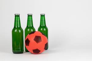 Bottles of fresh beer with soccer ball