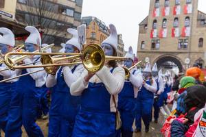 Brass band from South German region Allgäu marches in The Smurfs costumes in front of the Severinstorburg at the Rose Monday parade during the Cologne Carnival