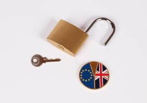 Brexit medal coin with open padlock and key on white background (Flip 2019)