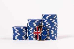 Brexit medal coin with poker chips on white background