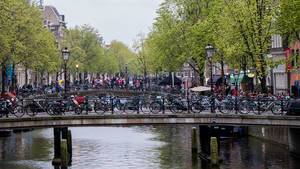 Bridges full of bicycles and people crossing in the red light district in Amsterdam
