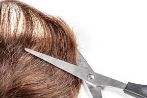 Brown hair with scissors on white background