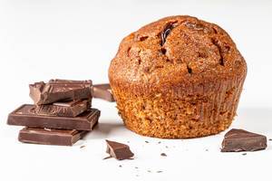 Brown muffin with chocolate pieces on white background (Flip 2019)