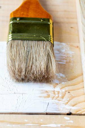 Brush for paint lies on being redecorated boards