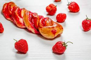 Bun with strawberry jam and fresh strawberries