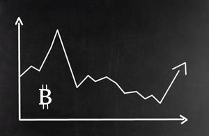 Business chart displaying Bitcoin market on blackboard