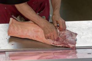 Butcher processing meat at Danilovsky Market in Moscow