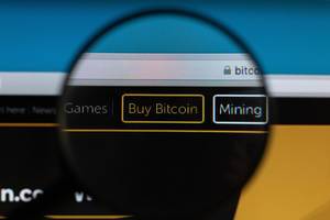 Buy Bitcoin button under magnifying glass
