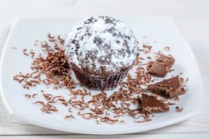 Cake with chocolate on a white plate