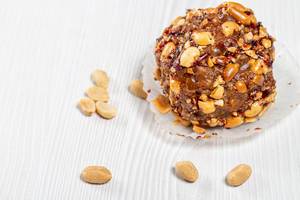 Cake with cocoa and roasted peanuts on a white wooden background (Flip 2019)