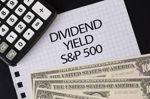 Calculator, money and Dividend Yield S&P 500 text on black table