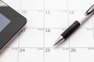 Calendar with pen and tablet symbolizes appointments