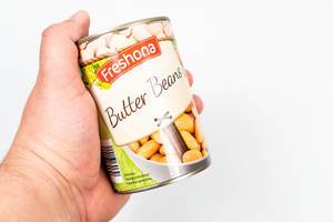 Canned White Beans in the hand above white background
