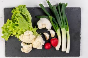 Cauliflower Young Onions Garlic Red Radishes and Lettuce on the black tray (Flip 2019)