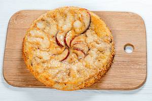 Charlotte apple pie on the kitchen board. View from above (Flip 2019)