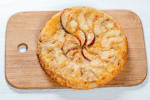 Charlotte apple pie on the kitchen board. View from above