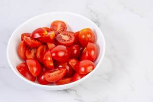 Cherry Tomatoes in the bowl on the grey marble board (Flip 2019)