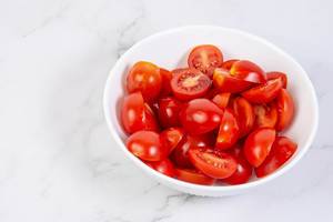 Cherry Tomatoes in the bowl on the grey marble board