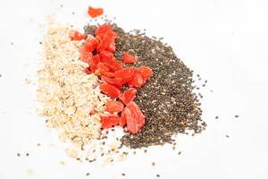Chia Seeds, Dried Papaya and Oatmeal above white background (Flip 2020)