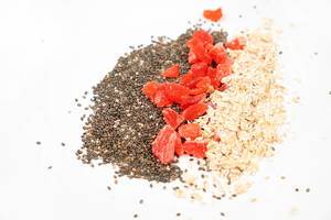 Chia Seeds, Dried Papaya and Oatmeal above white background