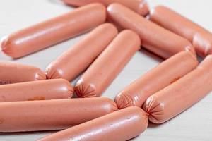 Chicken boiled sausages on a white background