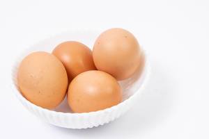Chicken Eggs in the bowl above white background (Flip 2019)