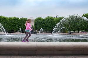 Child playing at fountains