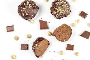 Chocolate cakes with chocolate pieces and hazelnuts on a white background