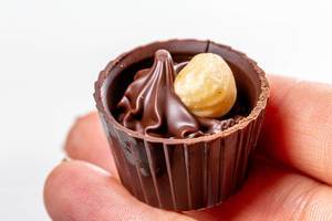 Chocolate candy with hazelnuts in a woman