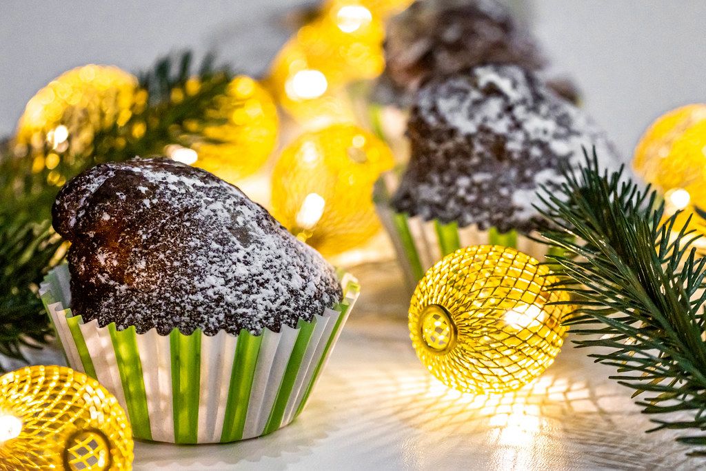Chocolate cupcake with Christmas tree branches and a luminous garland (Flip 2019)