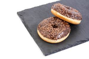 Chocolate Donuts on the black stone tray with copy space