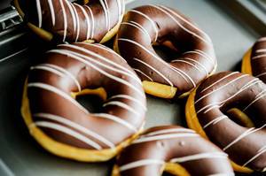 Chocolate glazed doughnuts in a tray