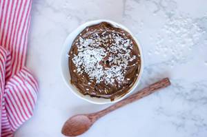 chocolate mousse with wooden spoon in sa white bowl  top view