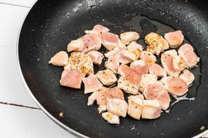 Chopped Chicken Breasts frying in the frying pan